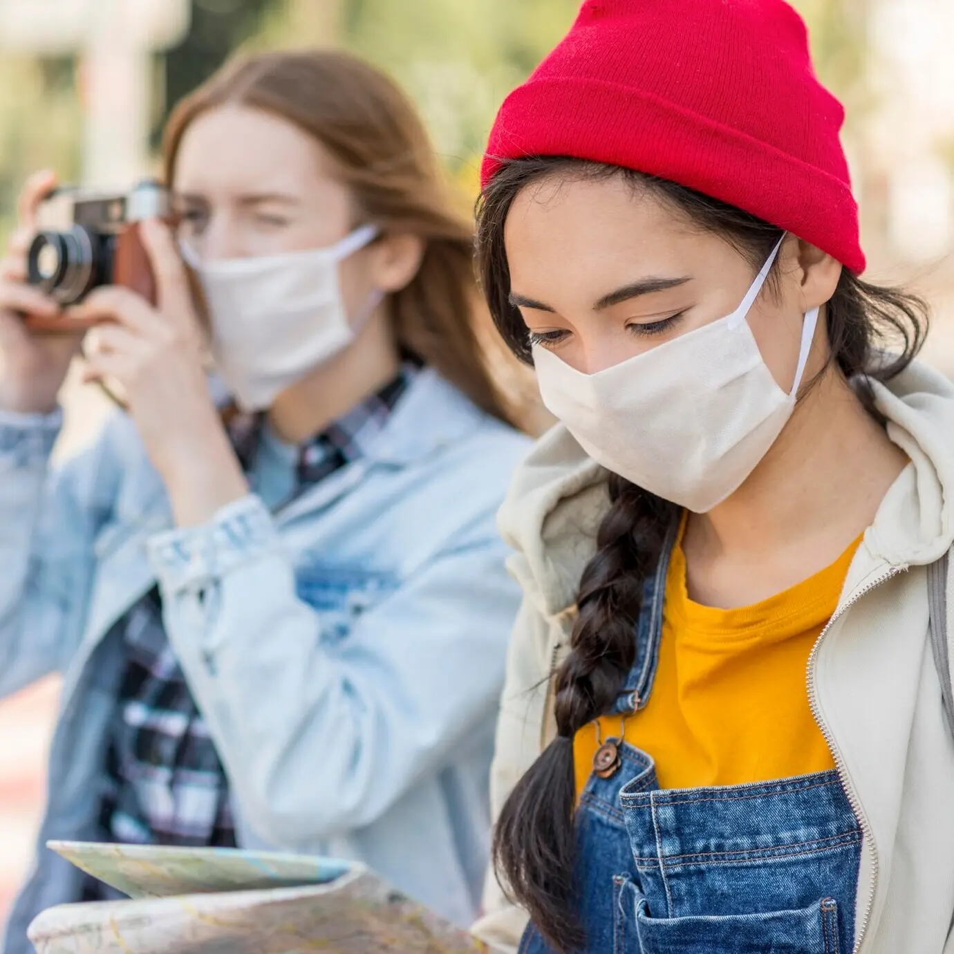 Young travelers wearing masks